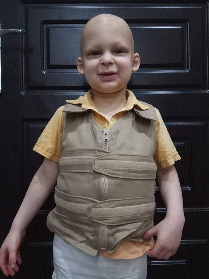 Boy wearing a khaki cool kids cooling vest
